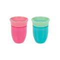 Two small Nuby 360 Wonder Cups (7 oz each, pink and aqua) sit side by side on a white background. Both spoutless cups have translucent lids and leak-resistant, wide openings, echoing the popular Wonder Cup design.