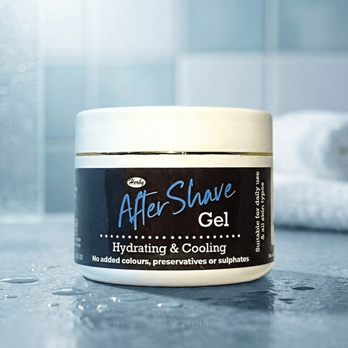 Herby After Shave hydrating and cooling balm jar displayed against a clean blue tiled bathroom background.
