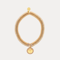 a gold bracelet with a round pendant