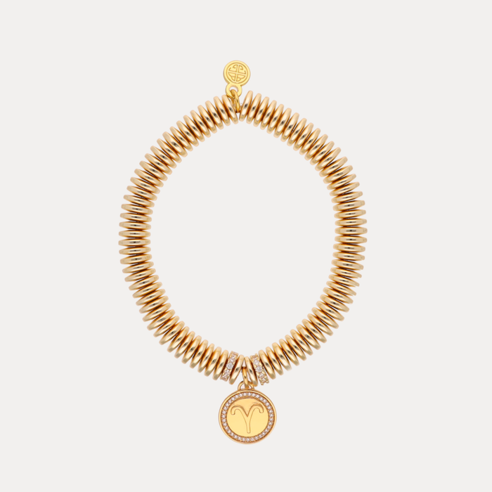 a gold bracelet with a round pendant