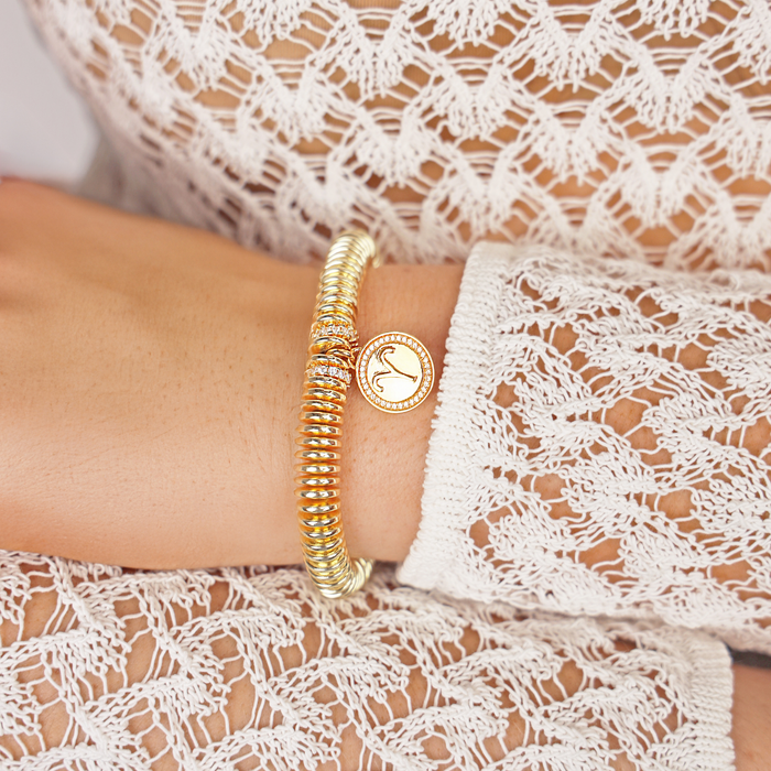 a person wearing a gold bracelet
