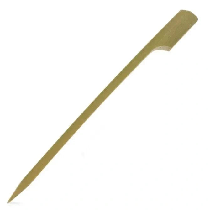 A single bamboo paddle pick, with a flat paddle-like end and a pointed tip, against a white background.