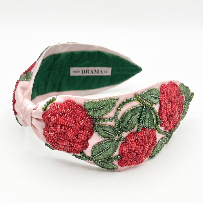 Hand-beaded rose headband with detailed embroidery in rich pink and green on satin base