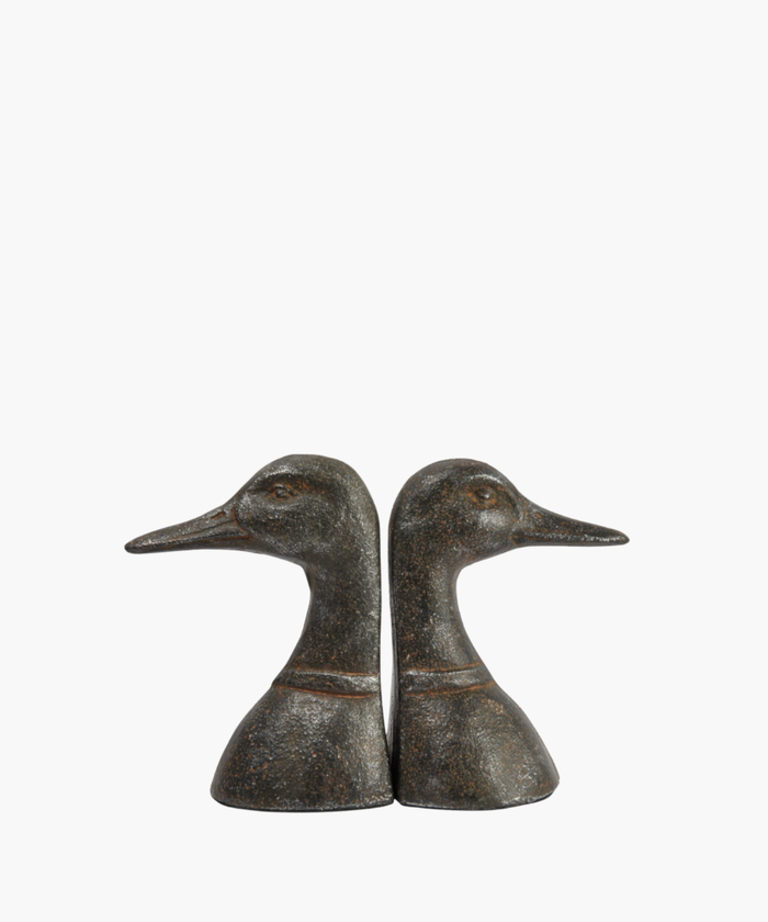 Two bronze duck head bookends face opposite directions against a white background. They feature detailed textures, conveying a classic and elegant tone. | SW Home