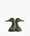 Two bronze duck head bookends face opposite directions against a white background. They feature detailed textures, conveying a classic and elegant tone. | SW Home