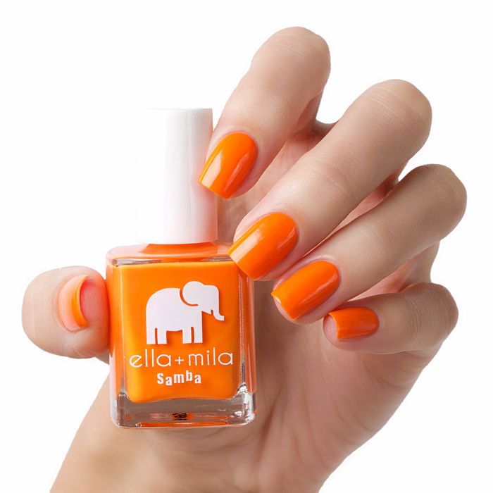 Cause I'm Happy neon orange nail polish manicure on a light skin tone with the bottle