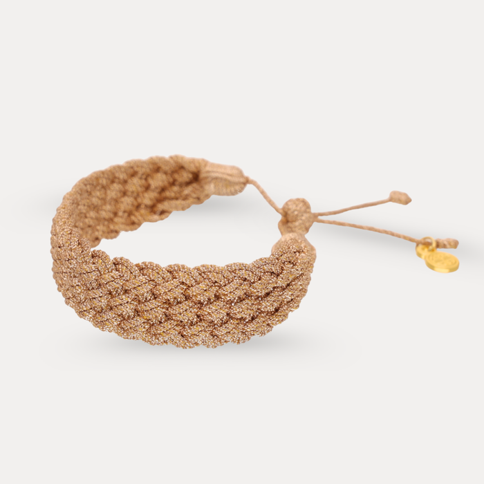 a brown woven bracelet with a gold tag