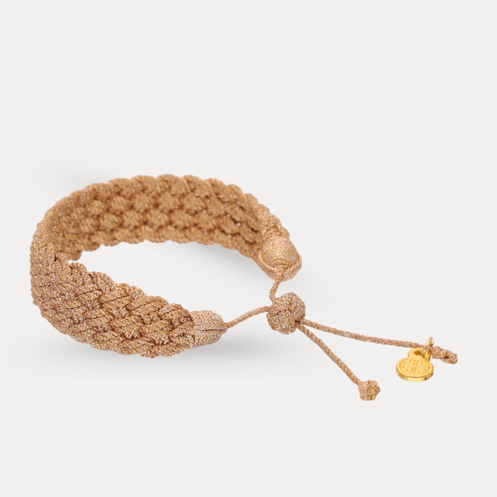 a gold bracelet with a knot