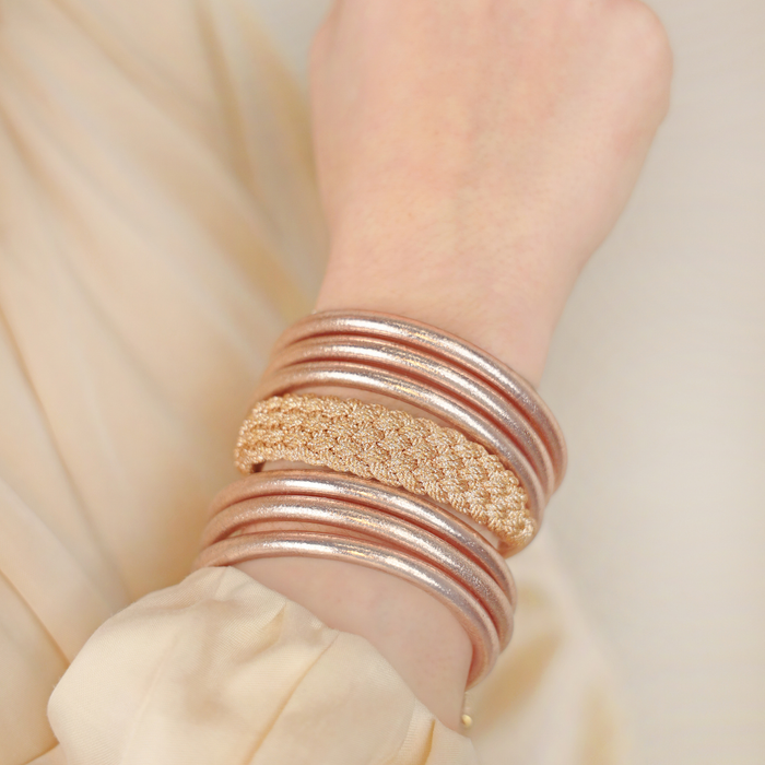 a person wearing gold bracelets