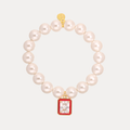 a pearl bracelet with a red square pendant