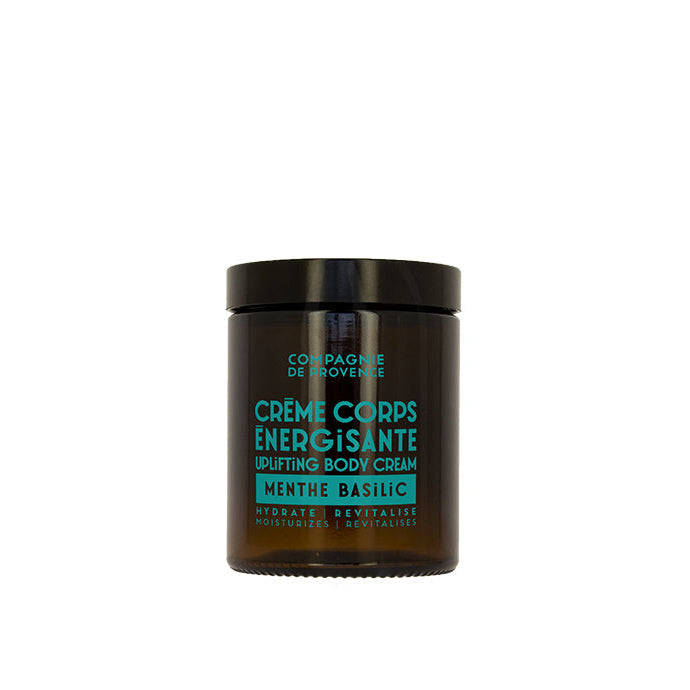 A jar of body cream with a label indicating it is an 'Energizing Body Cream' with mint and basil scents.
