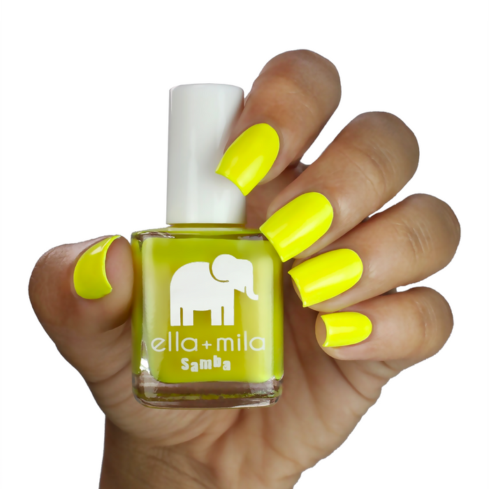 Copabikini bright yellow nail polish on a medium skin tone, hand holding the bottle