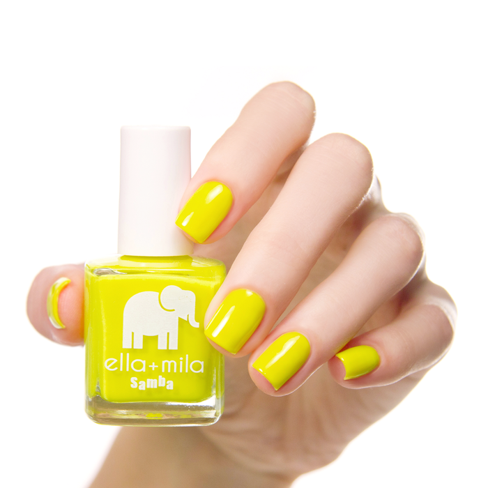 Copabikini yellow nail polish manicure on a light skin tone with the bottle