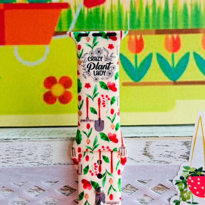 Crazy Plant Lady Apple Watch band with gardening tools, red flowers, and green leaves on cream background with garden decorations