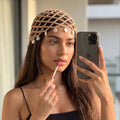 Beige crochet beanie cap with shell charms, perfect for beach days and resort escapes.