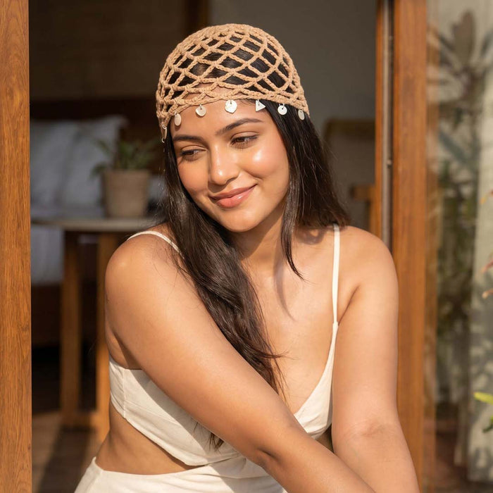 Boho crochet beach hat with shell detailing, styled for vacations and summer outings