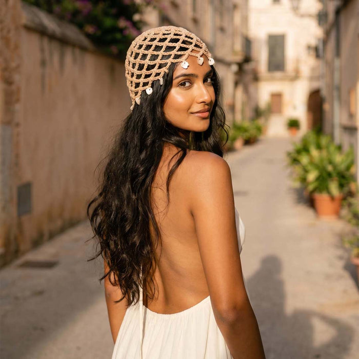 Lightweight crochet cap with shell charms, ideal for beach trips and café strolls.