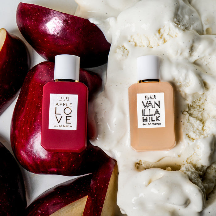 Apple Love 7.5ml Eau De Parfum Mini Dabber on sliced apples next to Vanilla Milk 7.5ml Eau De Parfum Mini Dabber on vanilla ice cream, on white background.