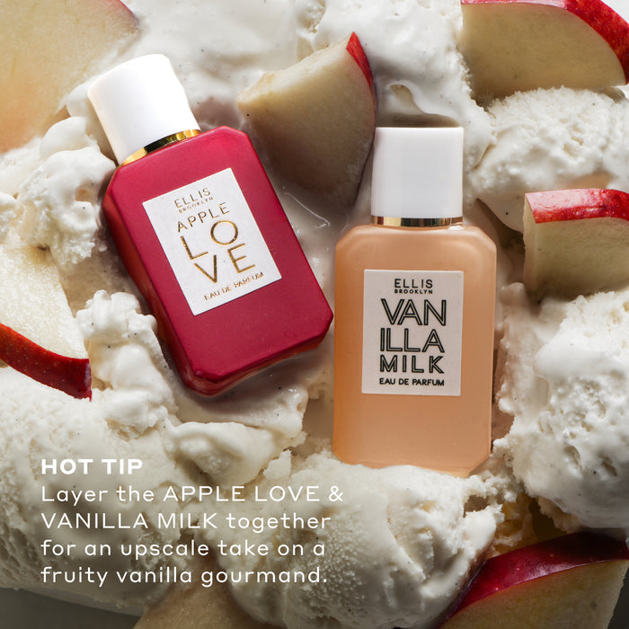 Apple Love 7.5ml Eau De Parfum Mini Dabber and Vanilla Milk 7.5ml Eau De Parfum Mini Dabber on sliced red apples and vanilla ice cream with white text that reads "Hot Tip Layer the Apple Love & Vanilla Milk together for an upscale take on a fruity vanilla gourmand."
