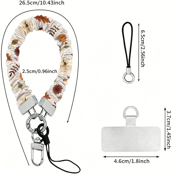 Dimension diagram for the Fall Floral Bliss scrunchie phone wrist strap: 26.5 cm strap length, 2.5 cm width, 6.5 cm loop cord, and a 4.6 by 3.7 cm phone attachment tab.