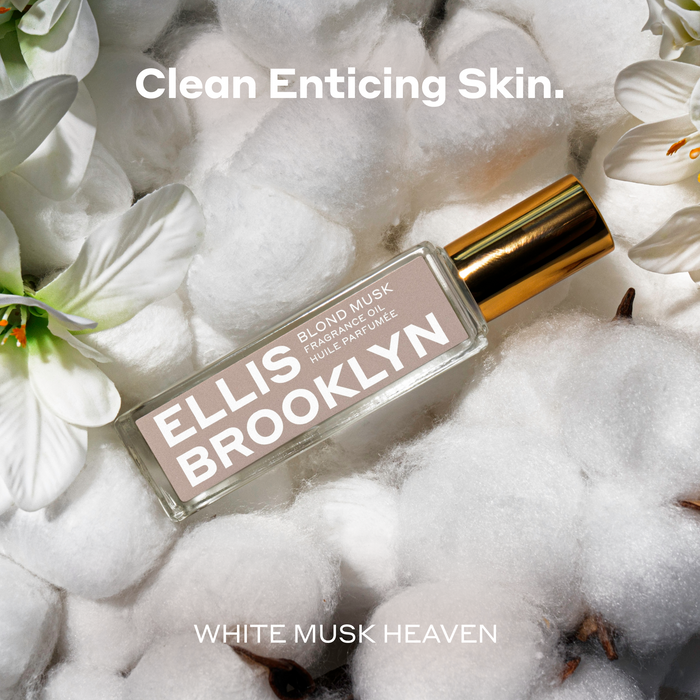 Blond Musk Fragrance Oil 15ml resting on cotton and white flowers between white text that reads "Clean Enticing Skin. White Musk Heaven".