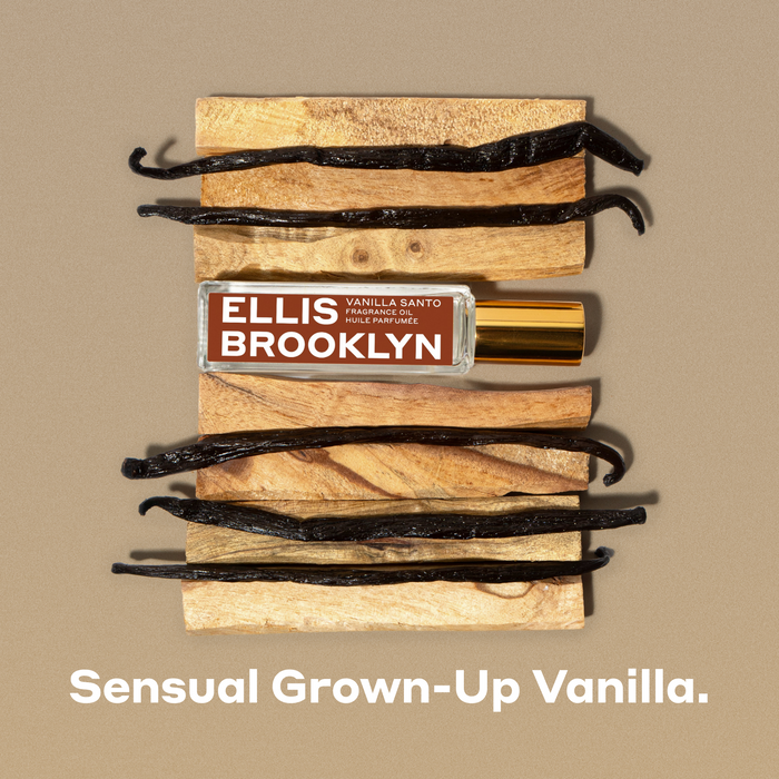 Vanilla Santo Fragrance Oil 15ml with pieces of wood and vanilla beans on brown background above white text that reads "Sensual Grown-Up Vanilla."
