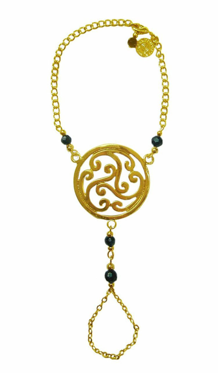 Gold Celtic swirl knot hand chain finger bracelet with dark bead accents front view