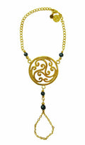 Gold Celtic swirl knot hand chain finger bracelet with dark bead accents front view