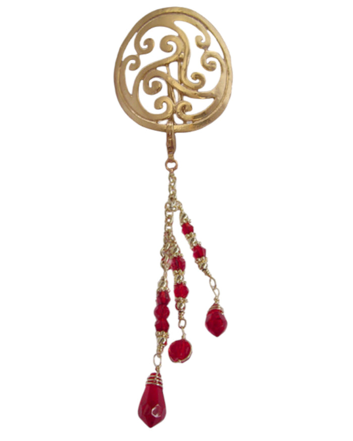 Gold filigree circle hair hook with dangling red bead charms, front view