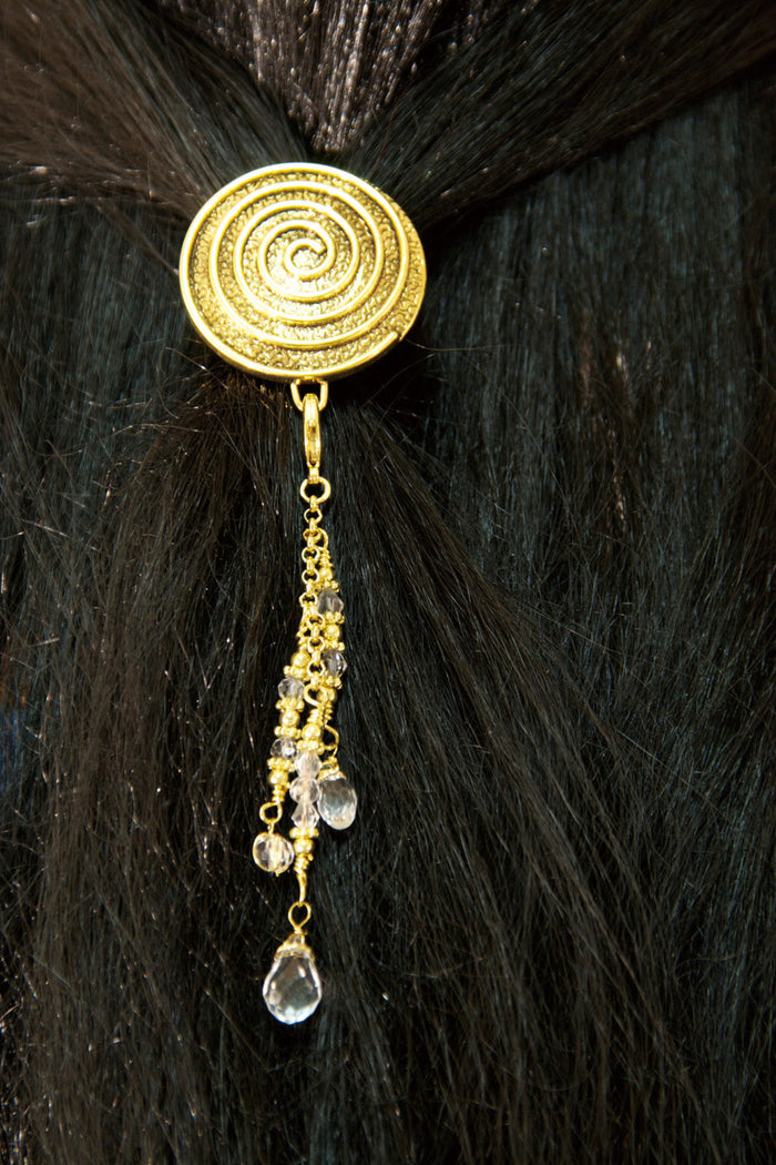 Gold spiral hair hook with dangling crystal bead charms worn in ponytail, back view