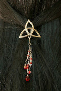 Silver Celtic triquetra hair hook with red bead charms in dark hair