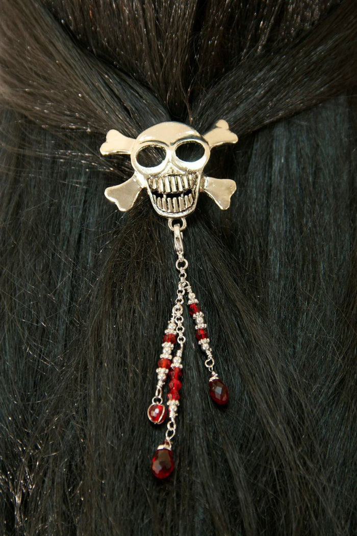 Silver skull hair hook with red bead charms worn in dark hair