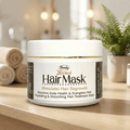 Herby Hair Mask jar displayed in a warm bathroom setting with folded towels, greenery and natural wooden decor.