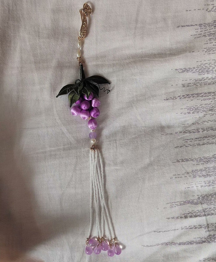 Handcrafted Chanhua thread-wrapped purple grape pendant with green leaves and a long white beaded tassel ornament.