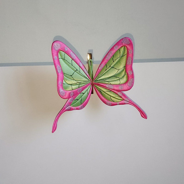 Handcrafted Chanhua thread-wrapped butterfly hair clip featuring a pink and green wing design with intricate patterns inspired by ninja aesthetics.