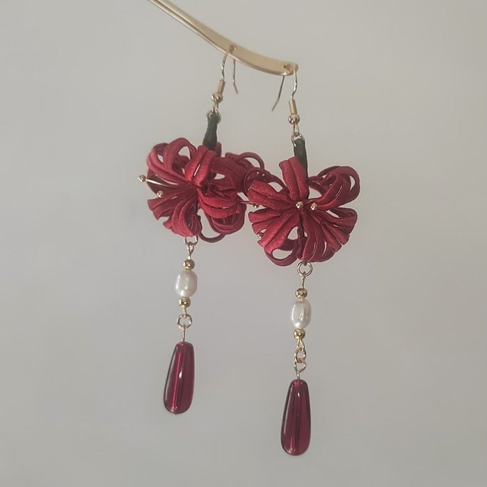 Handcrafted Chanhua thread-wrapped earrings in a red Spider Lily design with white pearls and deep red teardrop drops.