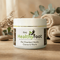 Herby Healthy Foot cream jar displayed in a relaxing bathroom setting with towels, plants and neutral natural decor.