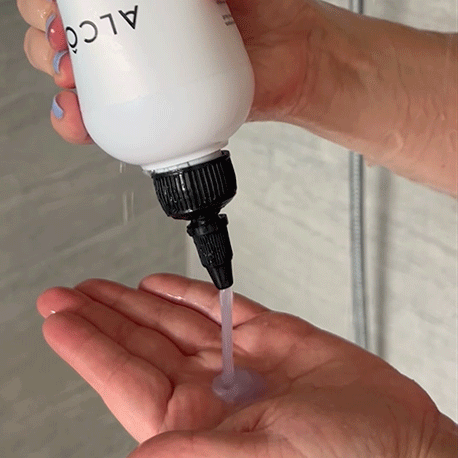 Hand pouring the shampoo in their palm