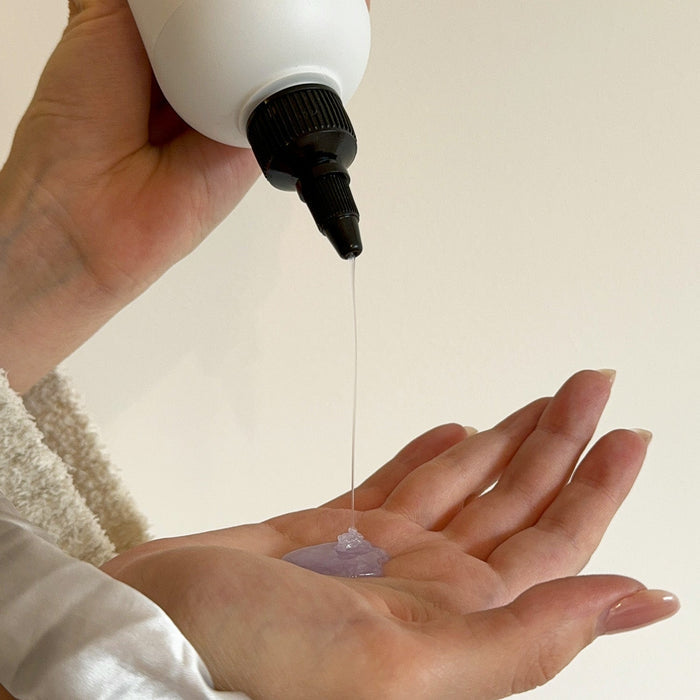Person pouring the Alcove Hair Hydrating Shampoo in her hand