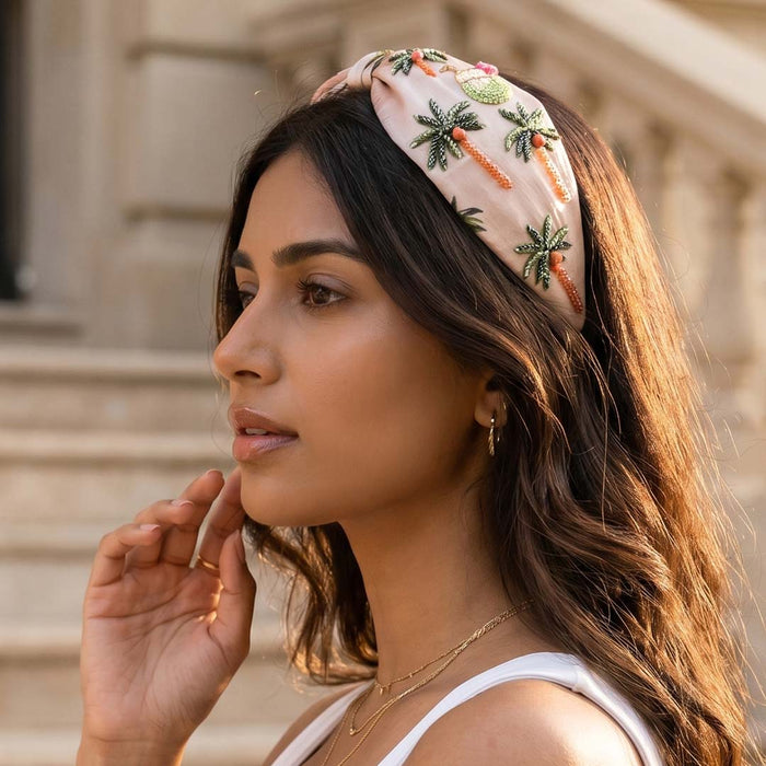 Embroidered tropical headband with palm leaves and coral beading on peach satin