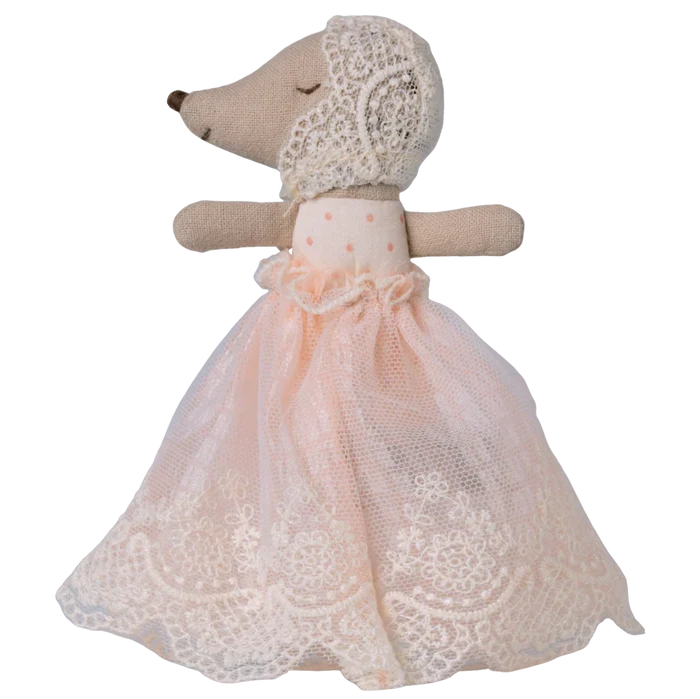 Stuffed animal toy with a lace dress on a white background