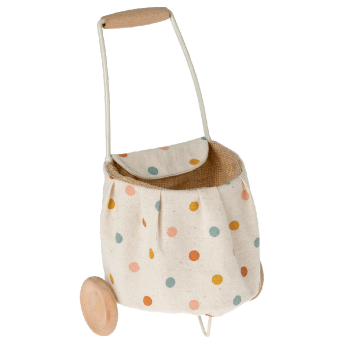A beige linen fabric trolley with multicolored dots, including a handle and wheels, designed for toy use.