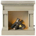 A miniature wooden fireplace with off white color and faux logs inside.
