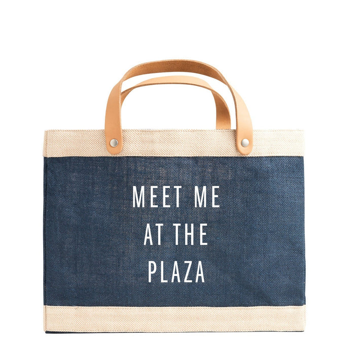 Blue tote bag with 'Meet Me at the Plaza' text on a white background