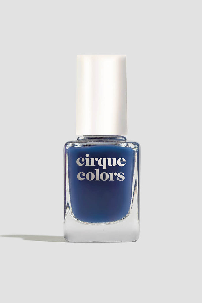 Close-up bottle shot of Cirque Colors Midnight Jelly, a dark blue jelly nail polish with a glossy finish