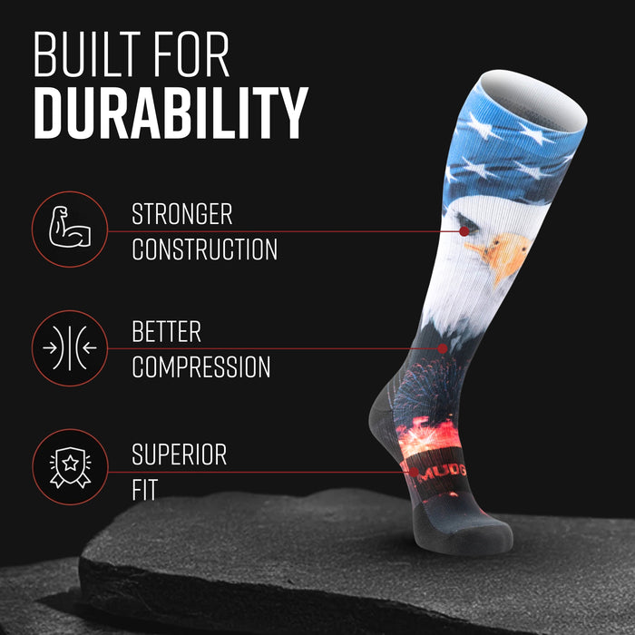 MudGear USA Eagle tall compression sock with blue sky, white clouds, eagle, and red fireworks design on black background