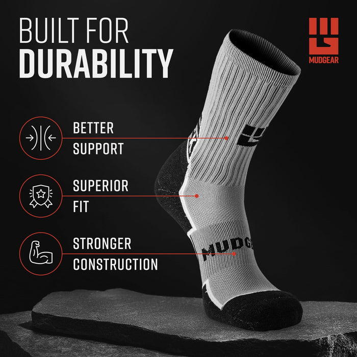 Gray and black MudGear Ruck Sock displayed on stone surface showing mesh venting and compression support