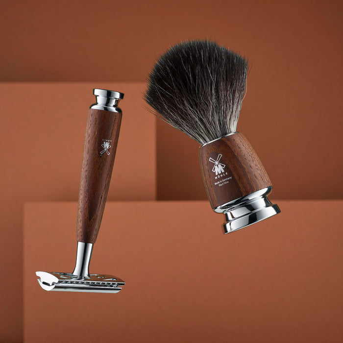 Shaving brush and razor on a brown background