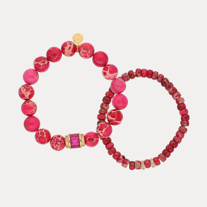 a pair of bracelets with pink stones
