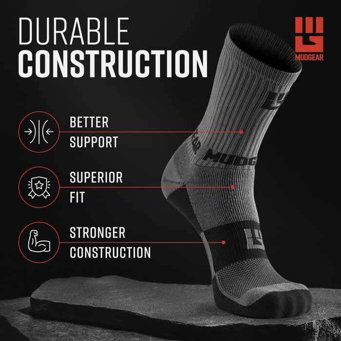 Gray and black compression hiking sock displayed on rock showing ribbed construction and support zones